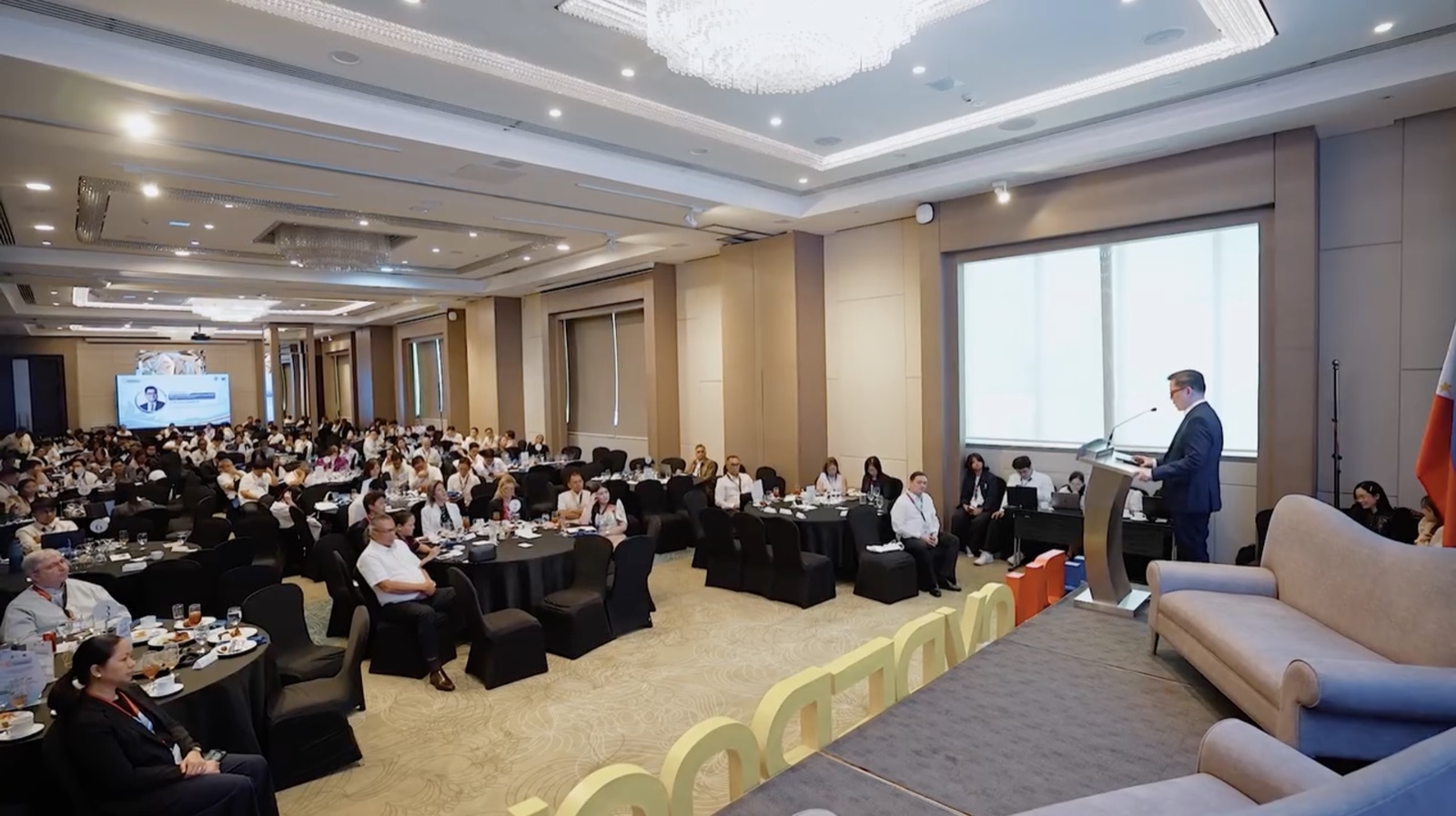 Attendees listen to a speaker at the podium during Philippine CyberCon 2026